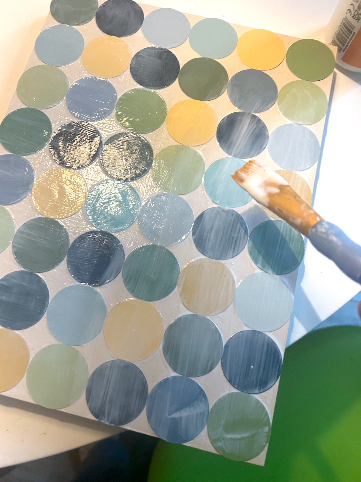 Applying a layer of Mod Podge over the top of the paint chips