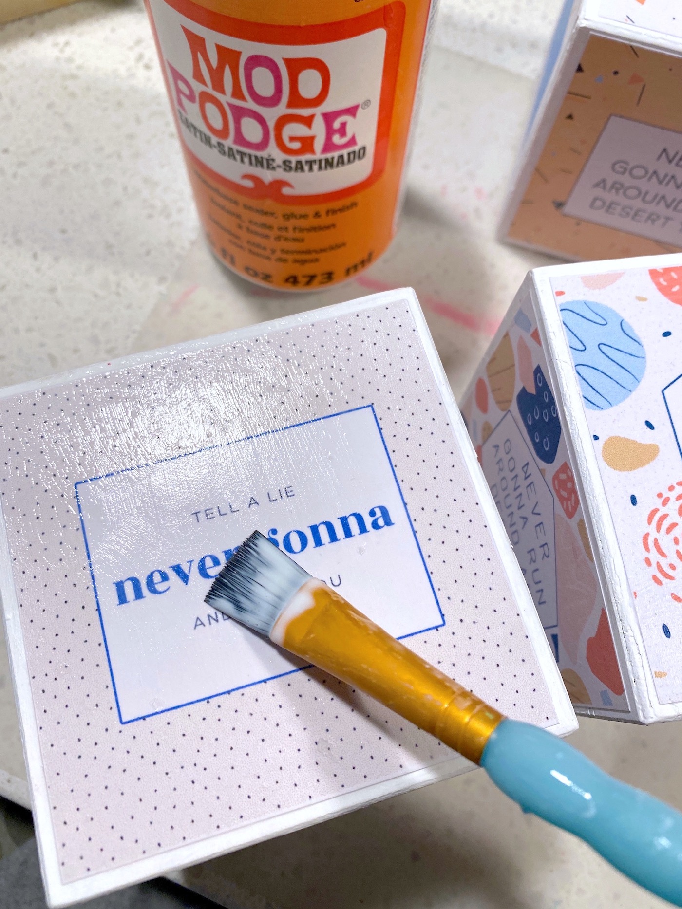 Applying a second layer of Mod Podge on the wood block