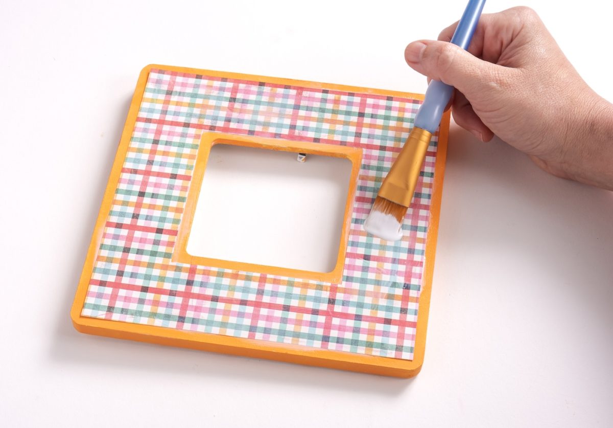 Applying a top coat of Mod Podge to the paper
