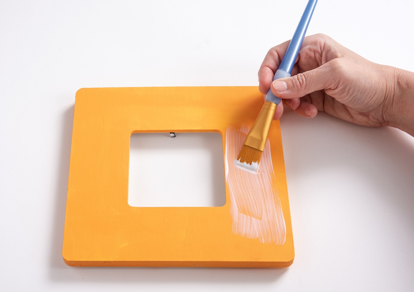 Applying Mod Podge to the top of the frame