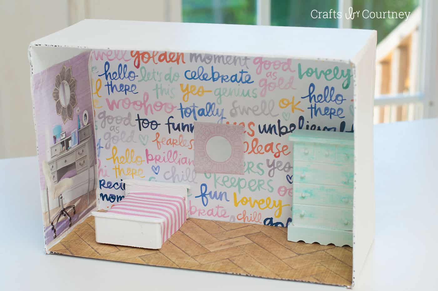 Don't spend big bucks on a dollhouse - this DIY dollhouse project will show you how to make an awesome version from a cardboard box!
