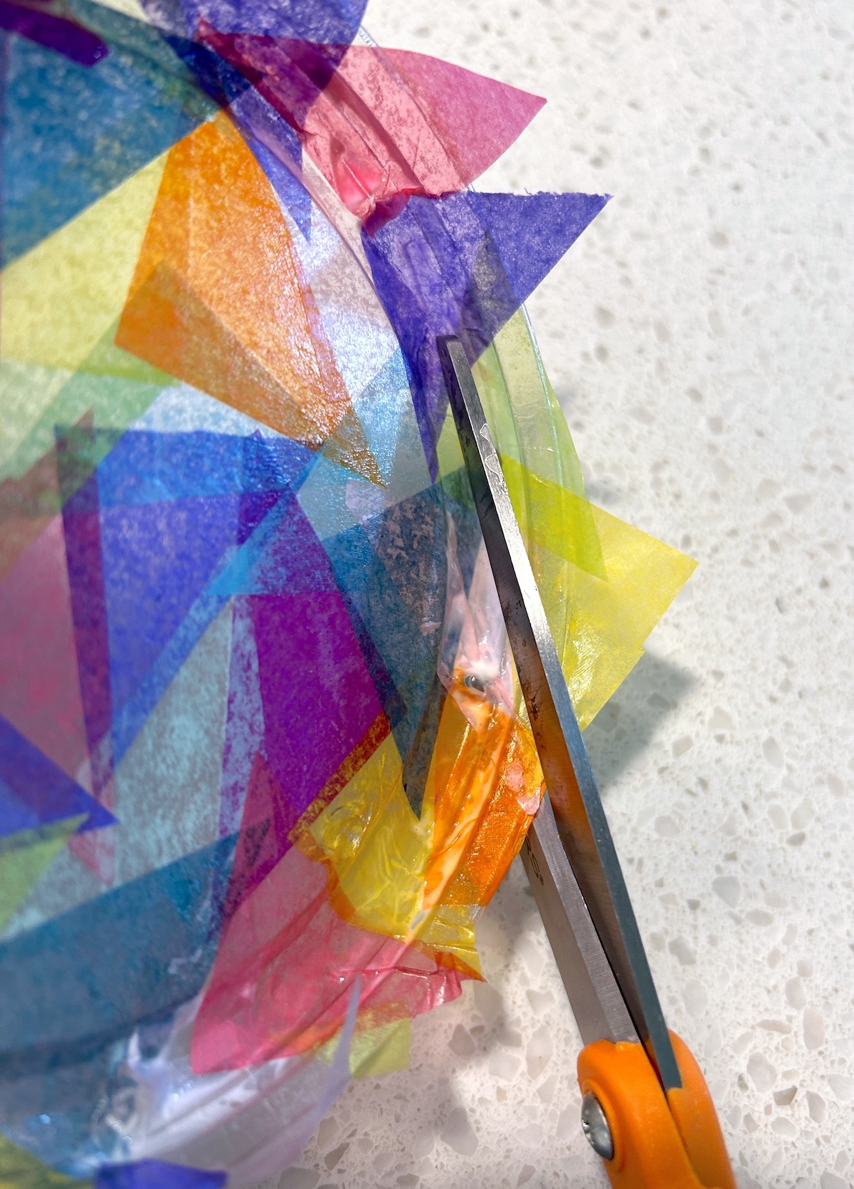 cutting the excess tissue paper with scissors