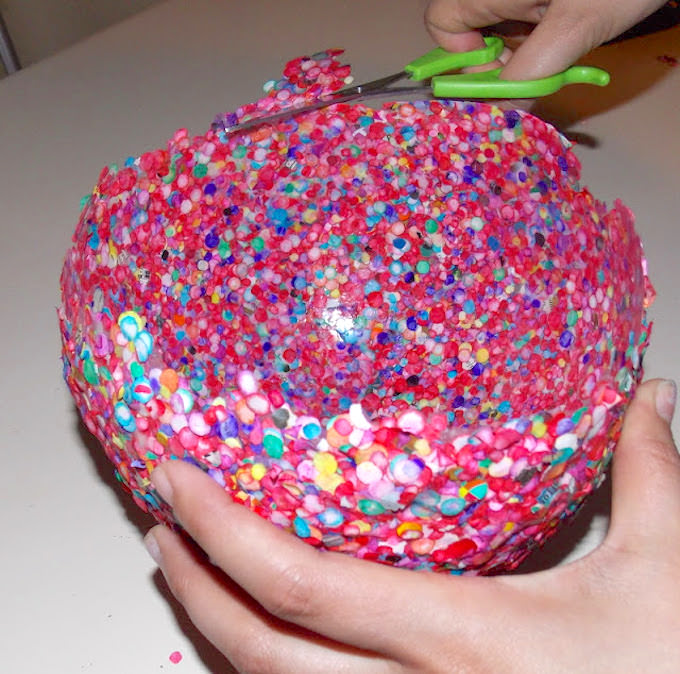 Trimming the edge of the confetti with scissors