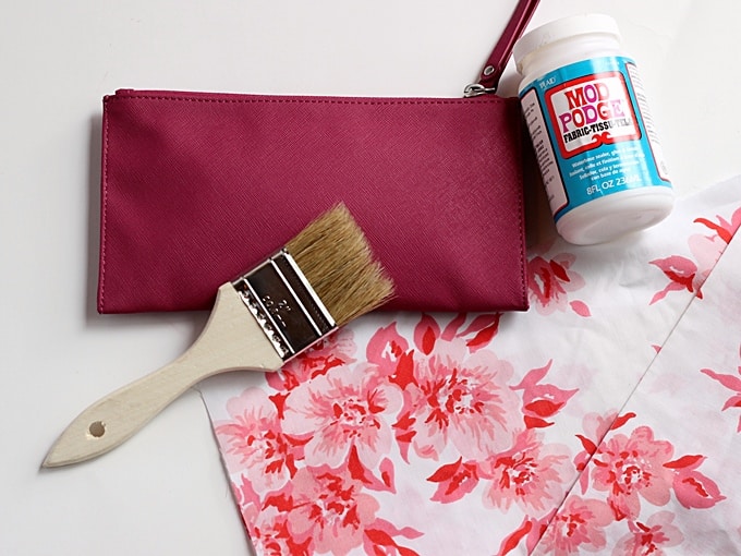 Purse, Mod Podge Fabric, floral fabric, and a paintbrush