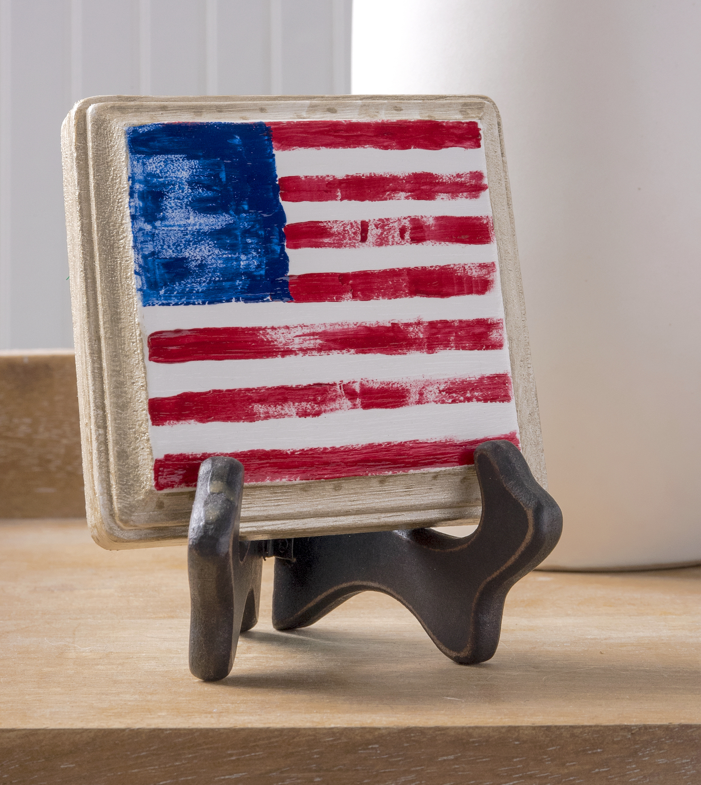 Finger painted American flag on a wood plaque
