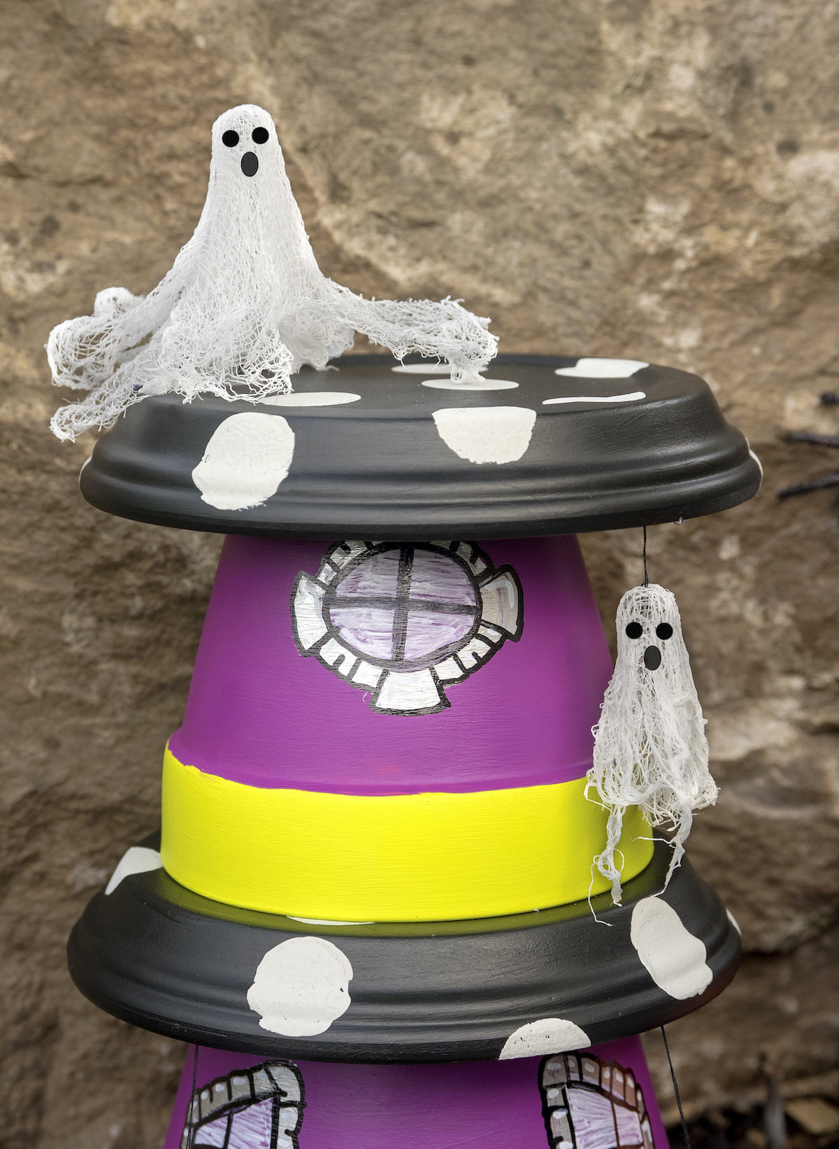 Ghost sitting on top of a fairy garden for Halloween