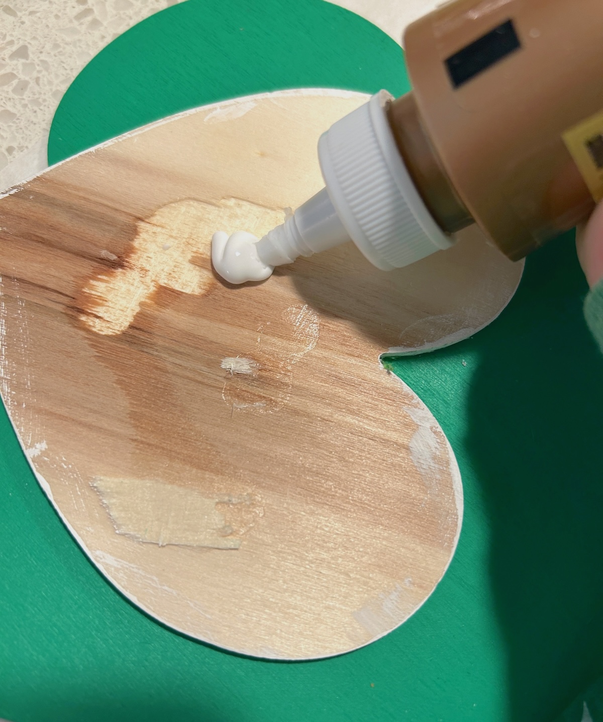 Gluing the hearts back onto the shamrock with craft glue