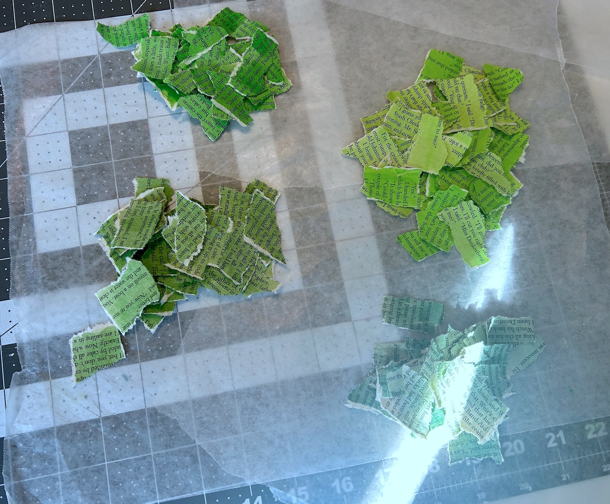 green painted book pages torn into pieces