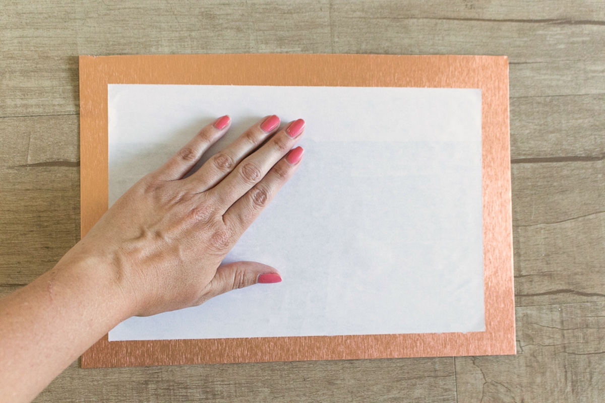 hand smoothing down the photo transfer