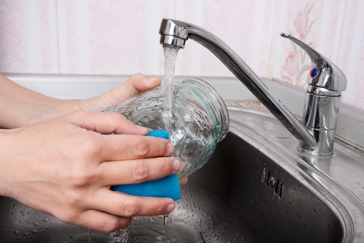 hands washing glass jar