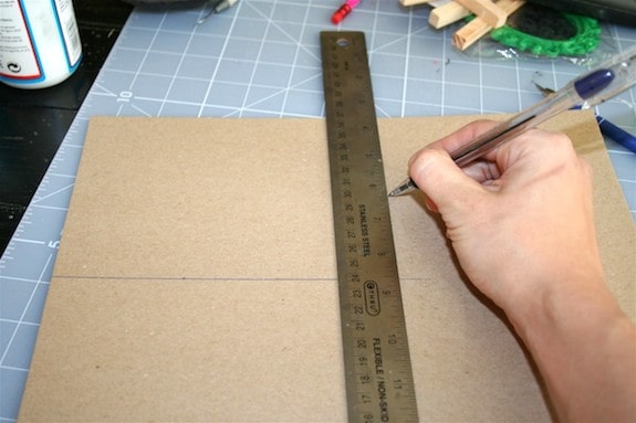 Making a line on a thin piece of cardboard with a ruler and pen