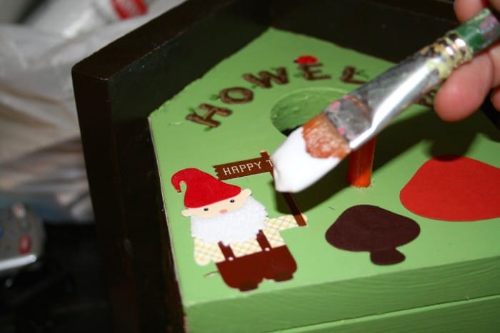 Painting the birdhouse embellishments with Mod Podge Outdoor