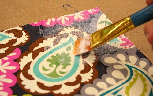 Painting a coat of Mod Podge over the top of the fabric