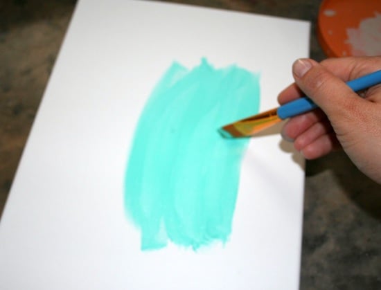 Painting on canvas with turquoise paint