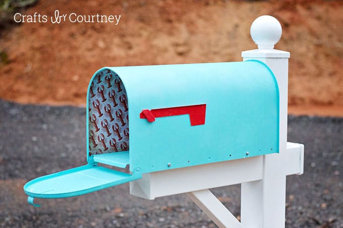 painted mailbox with scrapbook paper decoupaged inside