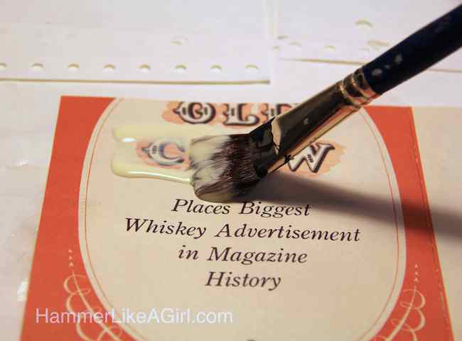 Spreading Mod Podge onto the back of a piece of paper