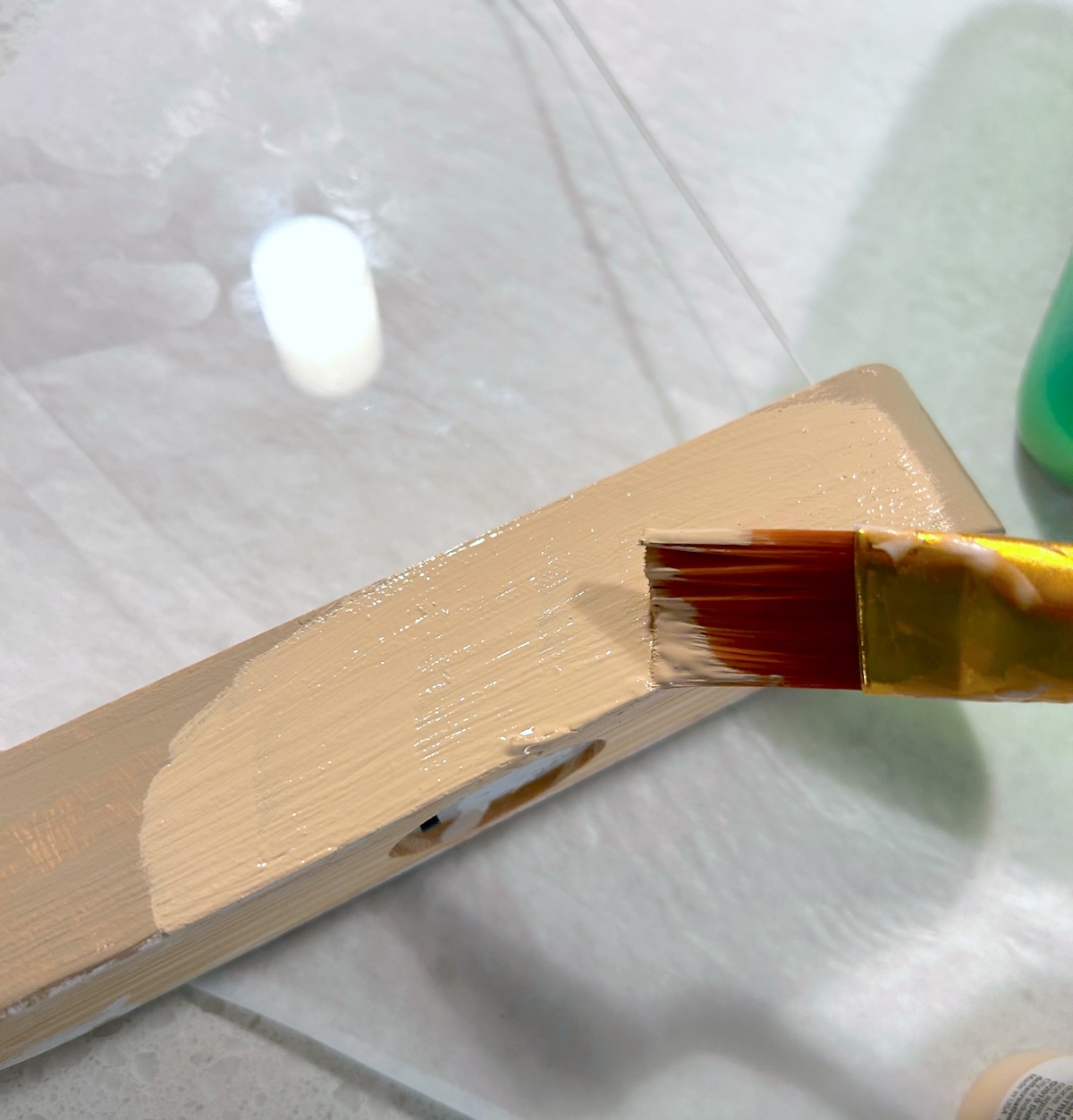 Painting khaki paint over the top of the wax