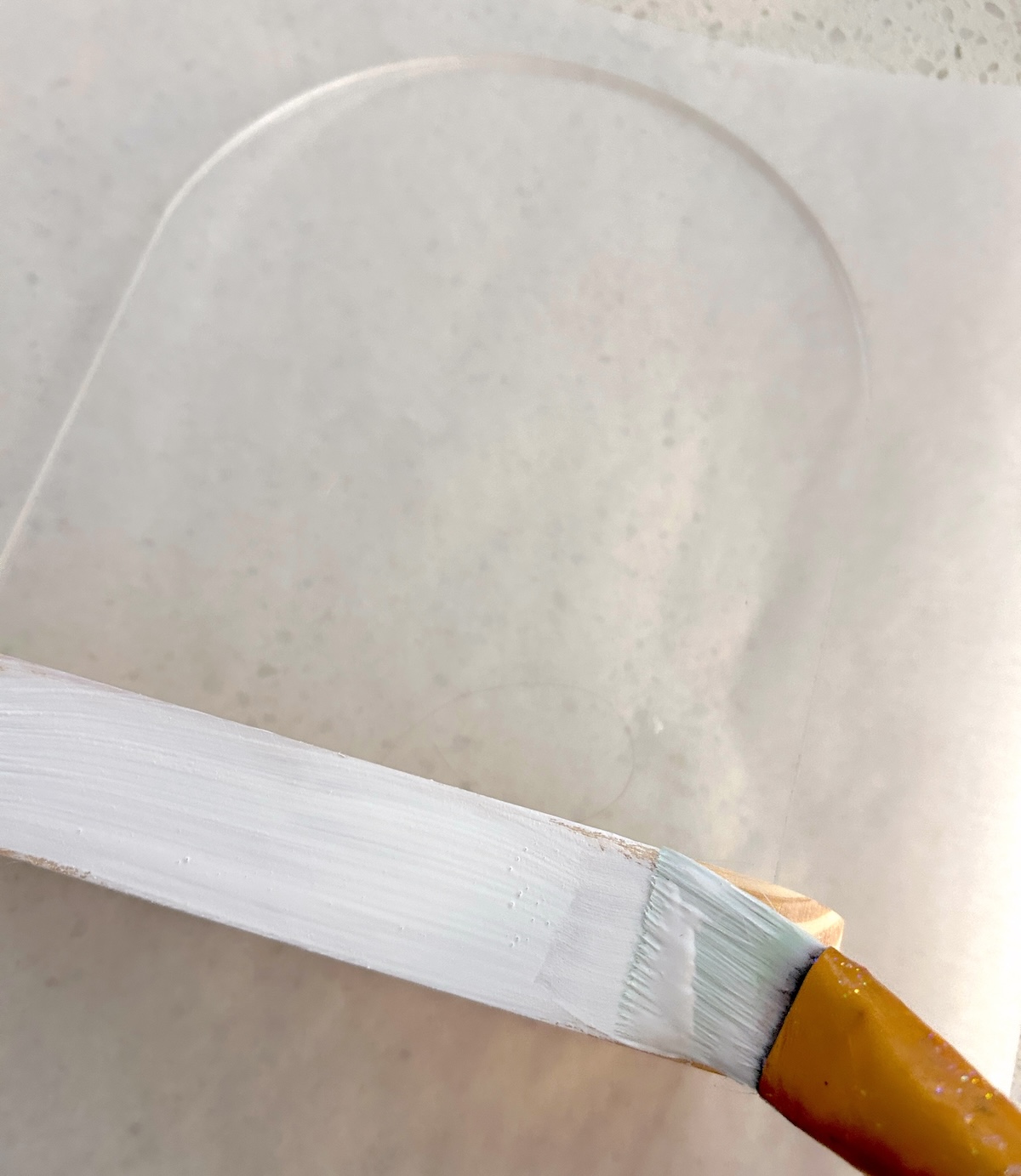 Painting the wood base with white paint