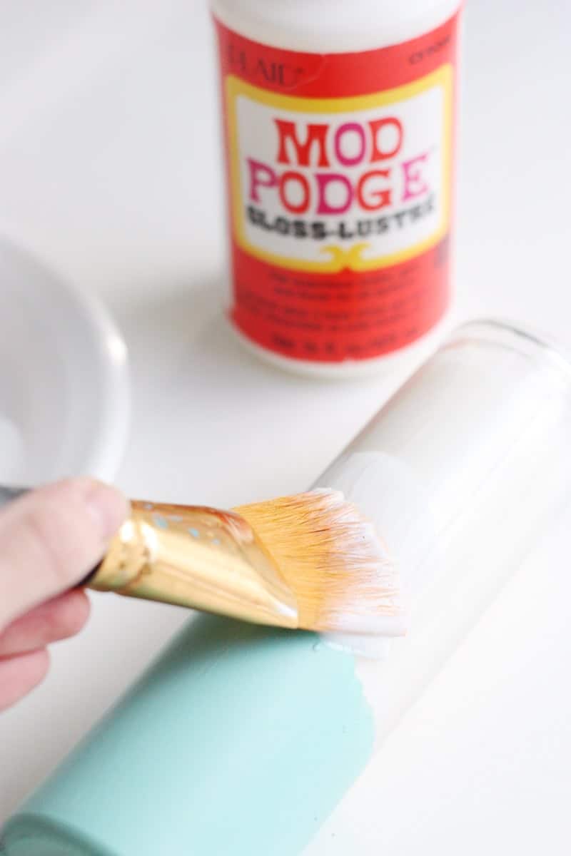 These paper-wrapped and paint-dipped candles use the power of Mod Podge to bring some springy life to some boring, dollar store candles.