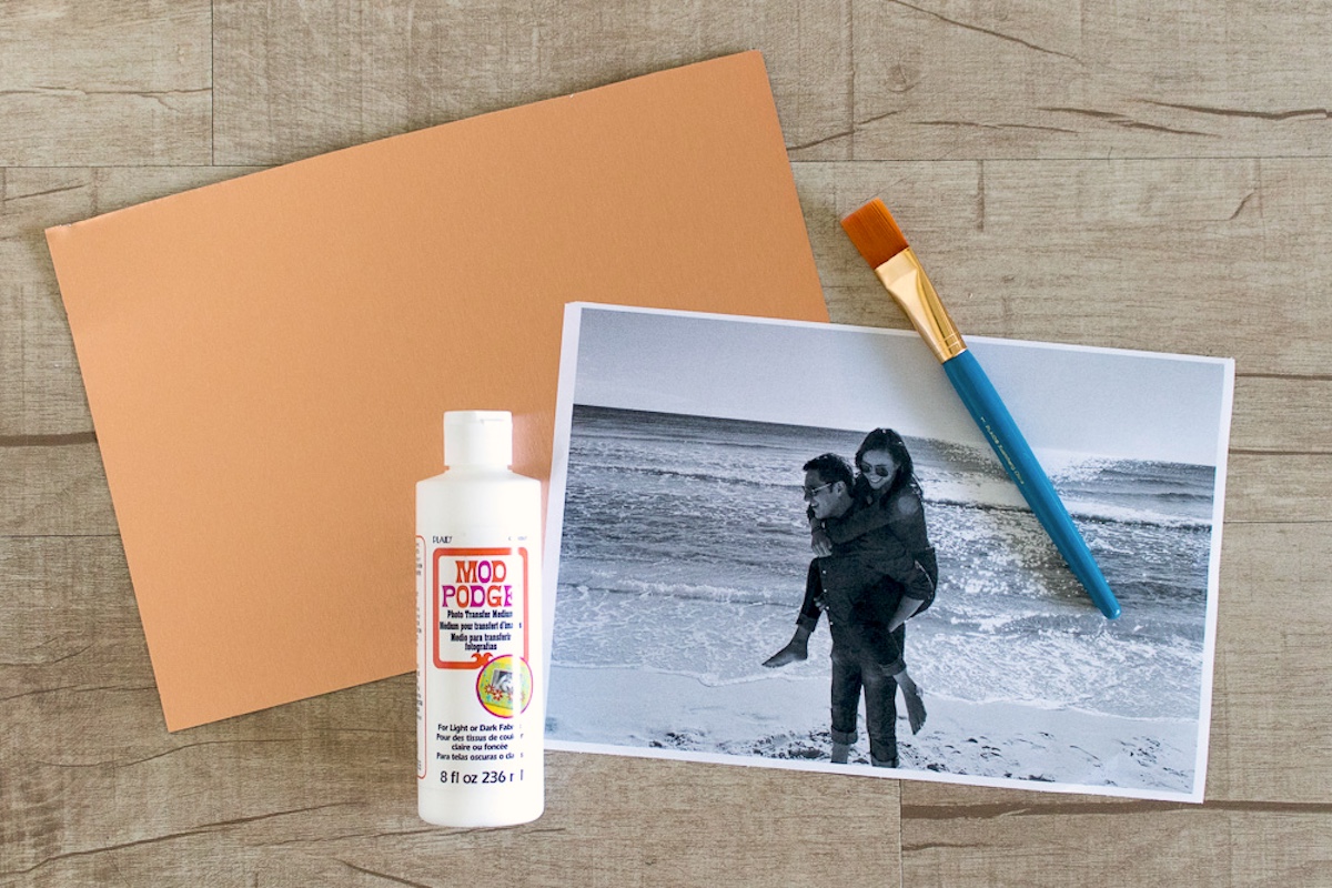 piece of metal, photo, photo transfer medium, and a paintbrush