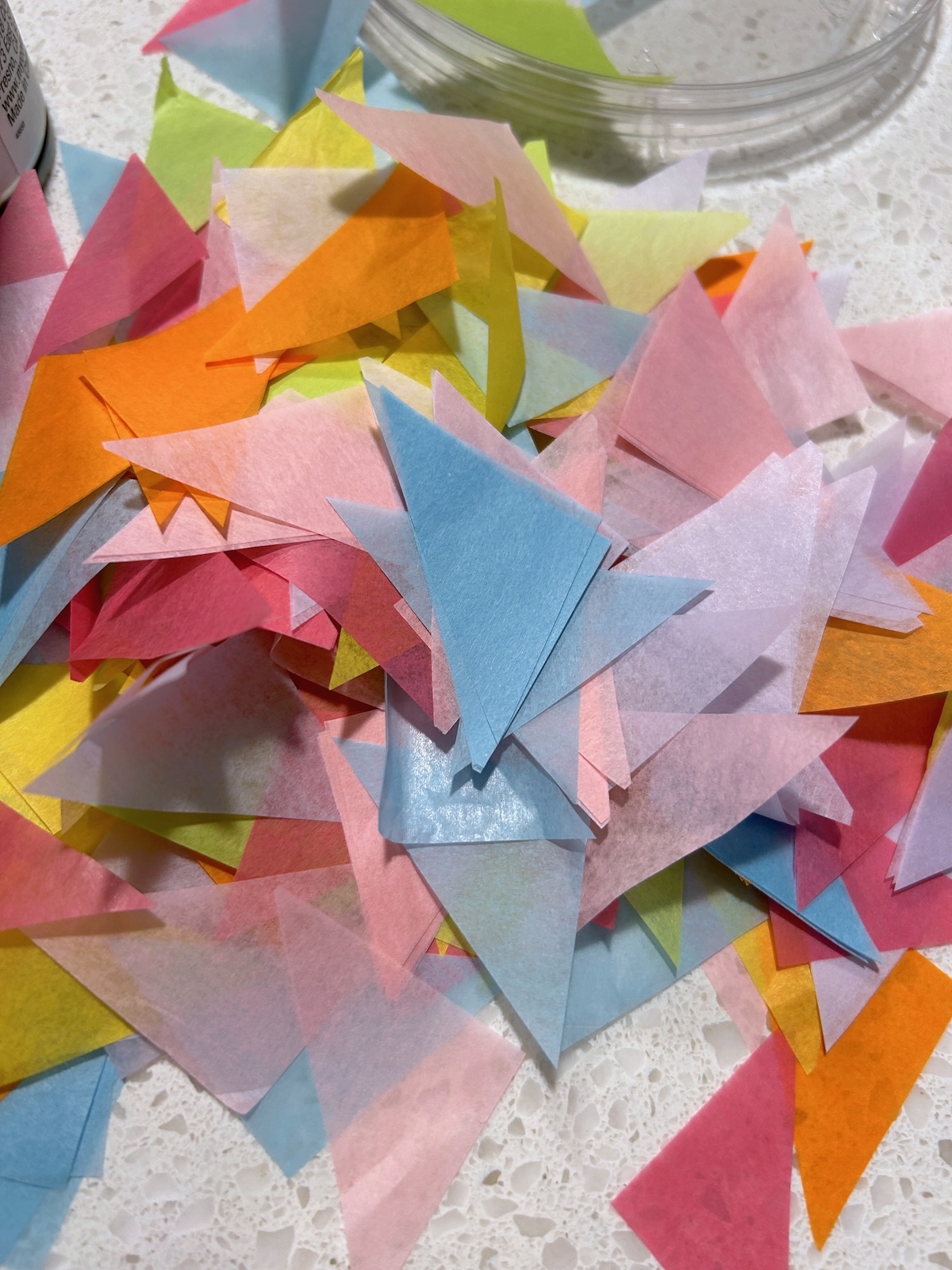 piles of cut triangles of tissue paper