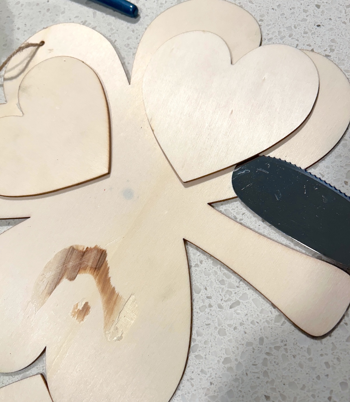 removing the wood hearts from the shamrock using a scraper