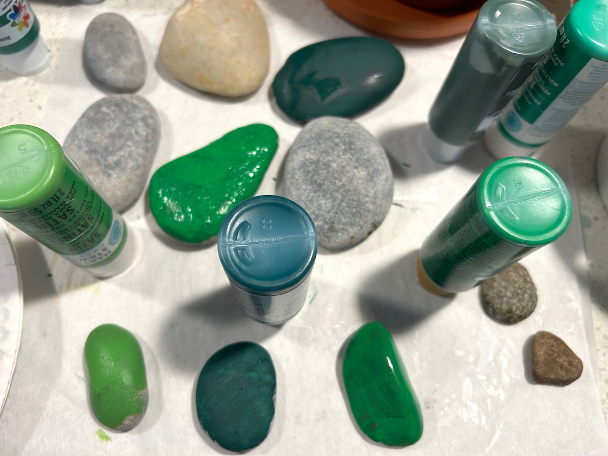 rocks painted with a single layer of green paint
