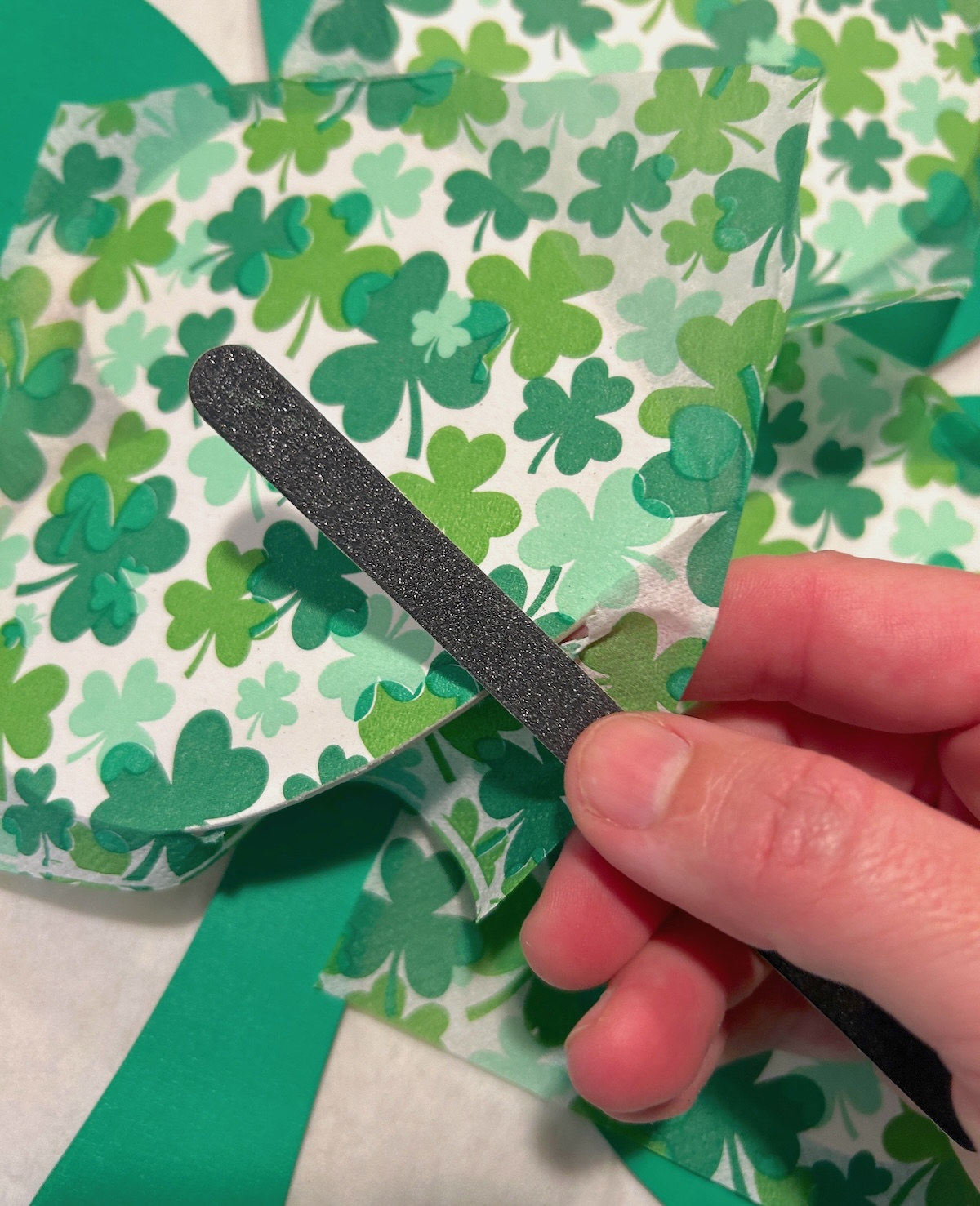 Sanding the edges of the heart shapes with a nail file