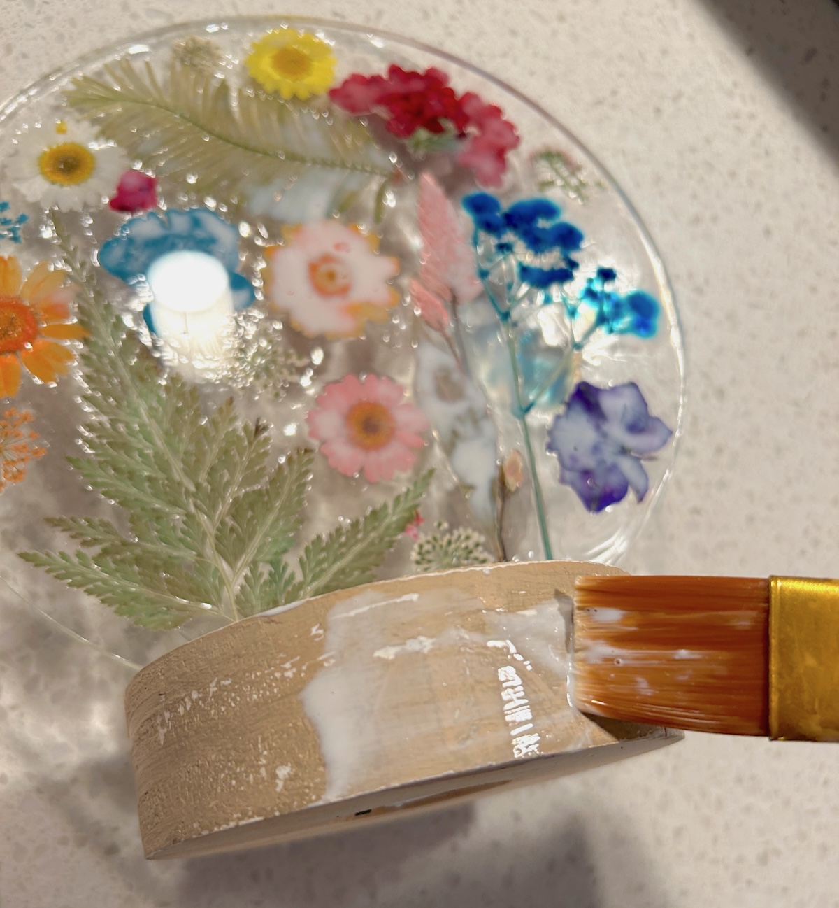 Sealing the base of the acrylic decor with Mod Podge