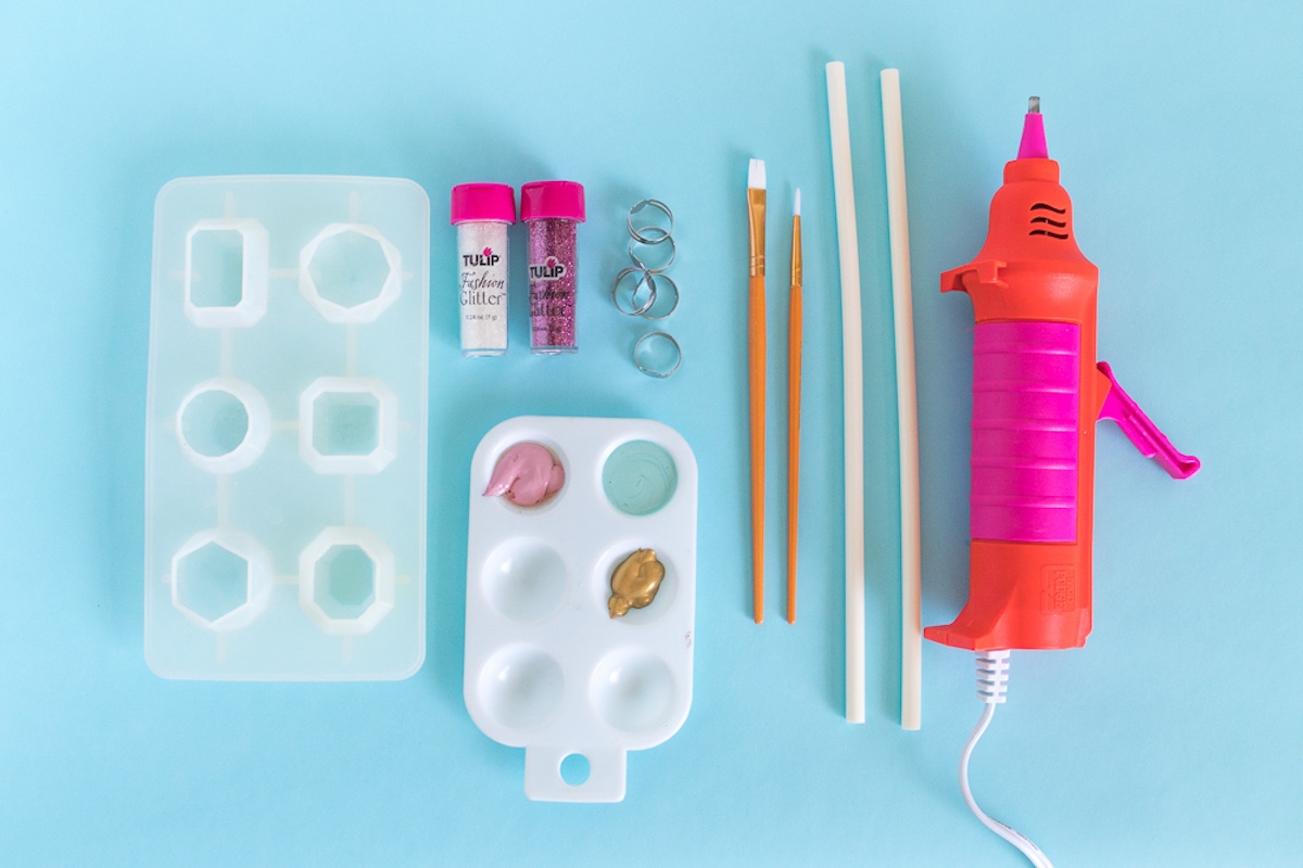 silicone gem mold, craft paint, hot glue gun, glue sticks, and ring blanks