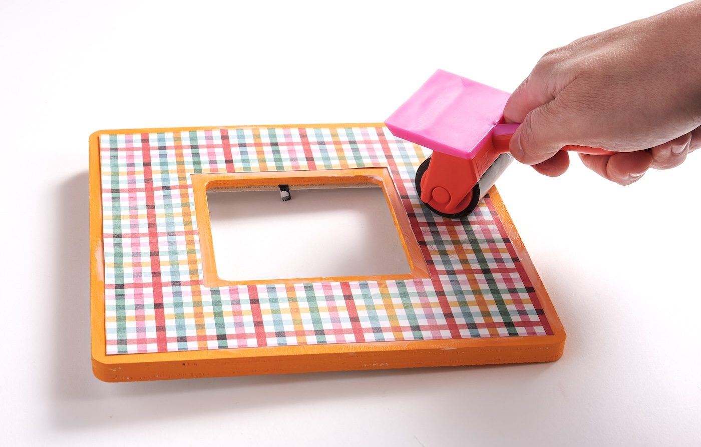 Smoothing the paper down with a brayer