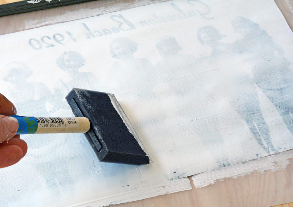 Spreading the medium across a photo with a foam brush