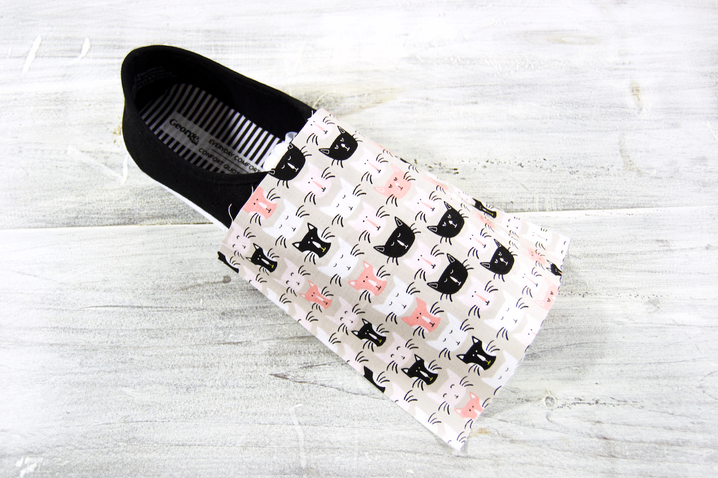 Square of fabric laying over the top of the shoe