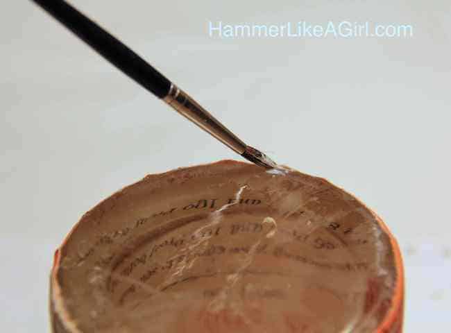 Touch up the edges of the paper on the glass with Mod Podge