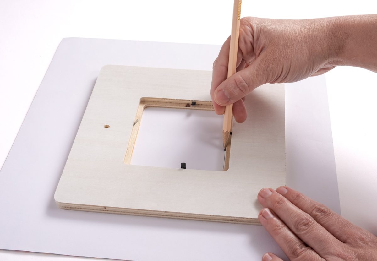 Tracing the frame on scrapbook paper with a pencil