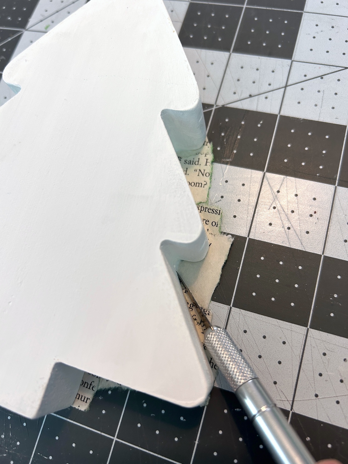 trimming the pages on the tree using a craft knife