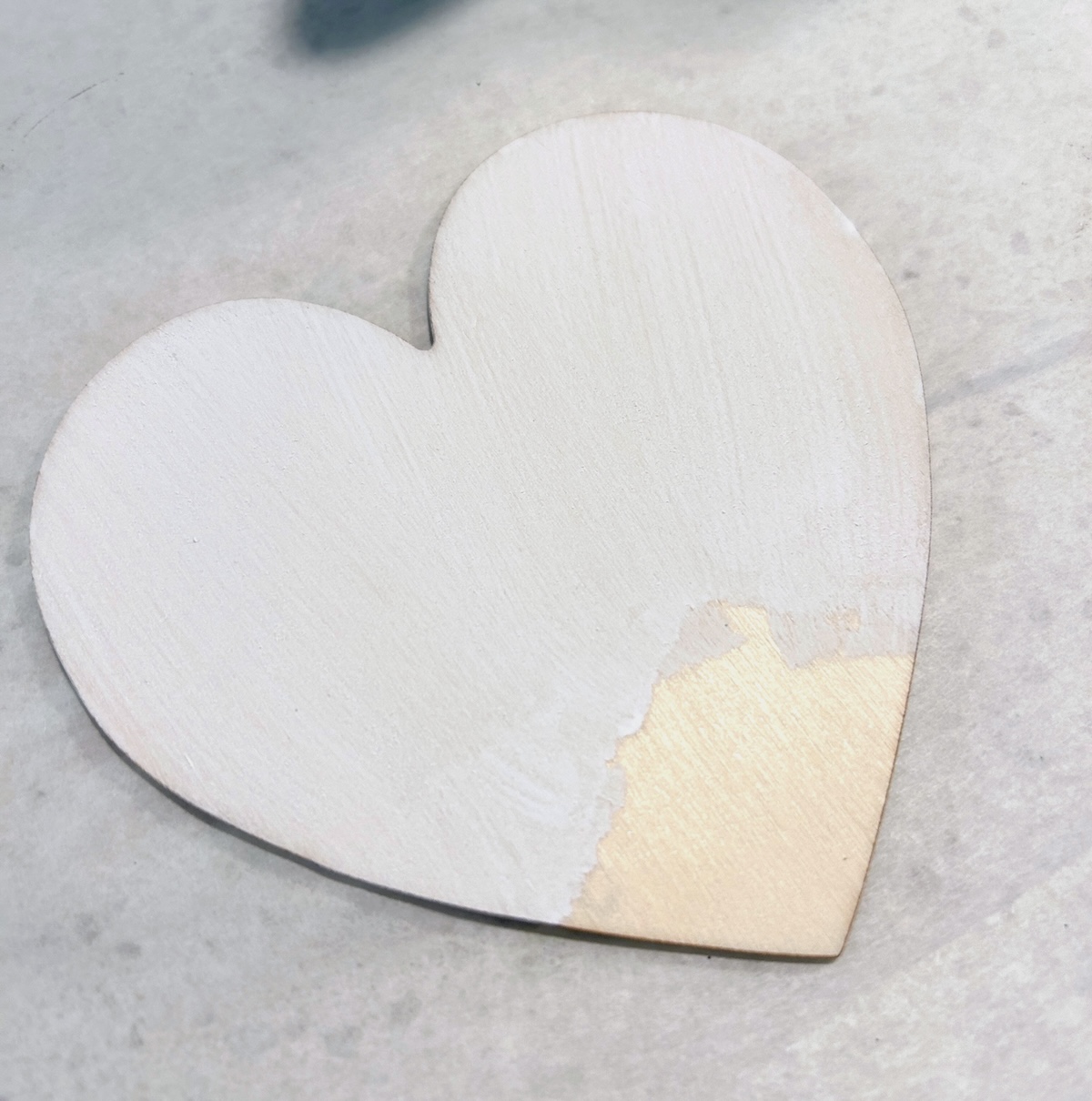 wood heart painted with white paint