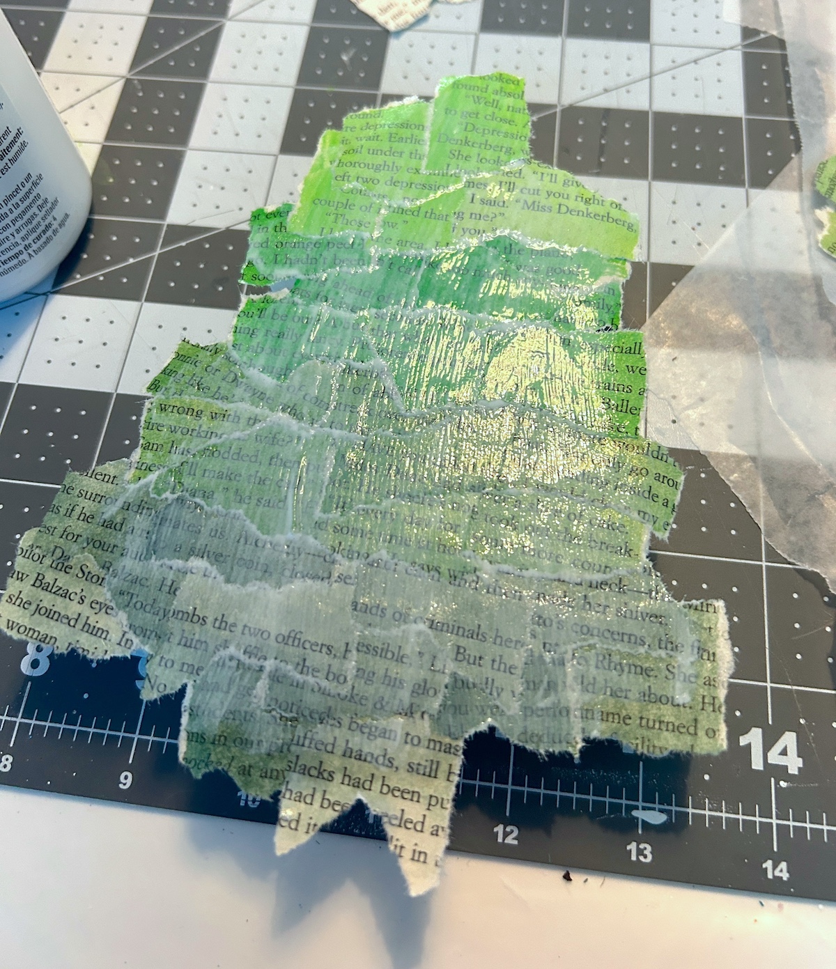 wood tree covered in book pages and Mod Podge